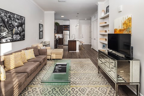 A living room with a brown couch and a coffee table.